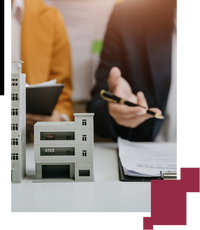 Miniatura de un edificio y personas detrás firmando documentos Miniatura de un edificio y personas detrás firmando documentos